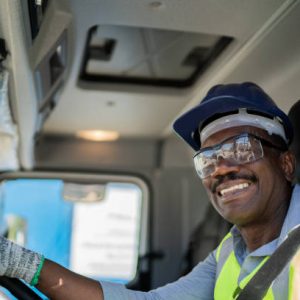 Portrait of a trucker driver inside the truck at a construction site